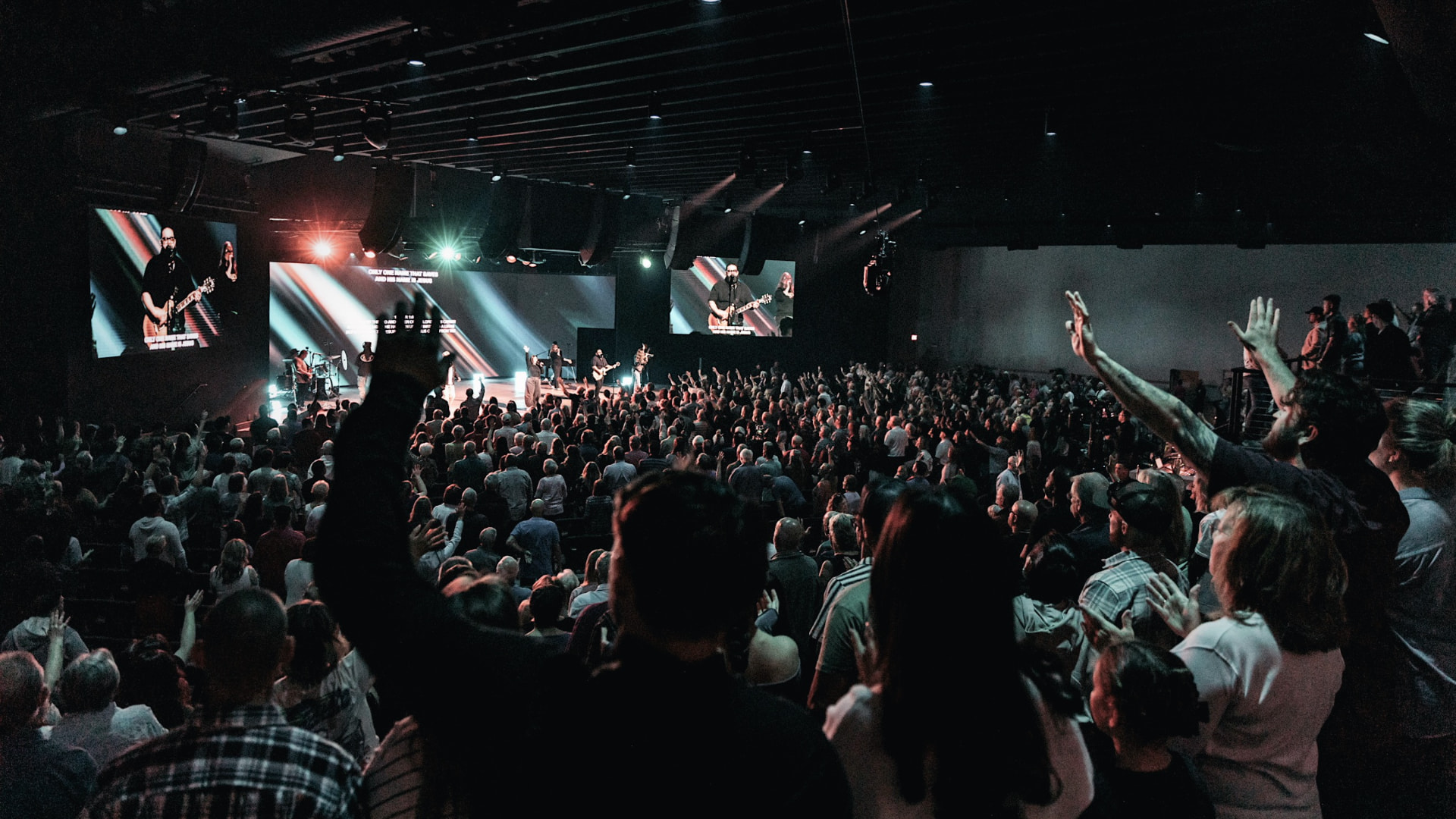 A congregation worshipping together with hands raised